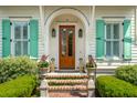 Elegant front entrance with brick steps, manicured greenery, and a beautiful wood door, offering a warm welcome at 28 Robert Mills Cir, Mount Pleasant, SC 29464
