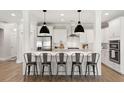 Modern kitchen featuring a large island with bar seating, stainless steel appliances, and pendant lighting at 2828 Wagner Way, Mount Pleasant, SC 29466