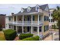 Beautiful yellow two-story home with a double veranda and well-maintained landscaping at 29 Smith St, Charleston, SC 29401