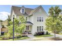 Inviting home with a classic design, featuring a well-maintained lawn and covered porch at 312 Greenhouse, Summerville, SC 29485