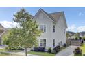 A beautiful home showcasing well-kept landscaping and a long private driveway at 312 Greenhouse, Summerville, SC 29485