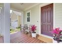 Cozy porch with chairs and a potted plant, inviting guests to relax near the front door at 312 Greenhouse, Summerville, SC 29485