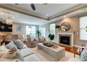 Open-concept living room with a fireplace, hardwood floors, and seamless access to the dining area at 314 Freeland Way, Moncks Corner, SC 29461