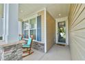 Welcoming front porch with rocking chairs, stone columns, and a cheerful entrance with wreath at 344 Seaside Trl, Summerville, SC 29486