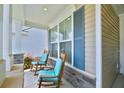 Cozy front porch featuring rocking chairs, decorative shutters, and a welcoming ambiance at 344 Seaside Trl, Summerville, SC 29486