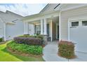 Inviting front porch with meticulously maintained landscaping, stone accents, and charming curb appeal at 344 Seaside Trl, Summerville, SC 29486