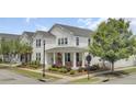 Beautiful two-story home showcasing a well-maintained lawn, charming front porch, and an inviting orange door at 351 Gnarly Oak Ln, Summerville, SC 29485
