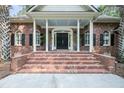 Close up of brick staircase and double door entrance with a covered front porch and white columns at 3555 Colonel Vanderhorst Cir, Mount Pleasant, SC 29466