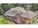 Back of home features a screened in porch, wood deck, and outdoor furniture at 3555 Colonel Vanderhorst Cir, Mount Pleasant, SC 29466