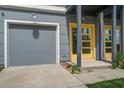 Modern townhouse exterior showcasing a yellow door and attached garage in a desirable neighborhood at 4067 S Rhett Ave, North Charleston, SC 29405