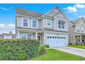 Beautiful two-story home featuring a two-car garage and a lush green lawn at 531 Crossland Dr, Moncks Corner, SC 29461