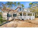 Charming home with a welcoming front porch, set amidst a lush, mature yard with beautiful trees at 62 Wexford Way, Walterboro, SC 29488