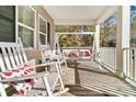 Relax on this spacious front porch featuring a swing and rocking chairs, perfect for outdoor living at 62 Wexford Way, Walterboro, SC 29488