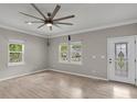 Bright living room with fresh paint, wood floors, and modern ceiling fan, featuring a decorative glass door at 62 Wexford Way, Walterboro, SC 29488