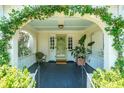Welcoming front porch with an arched entryway, decorative plants, and a cozy seating area at 66 Darlington Ave, Charleston, SC 29403