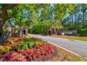 Landscaped community entrance of Saint Johns Lake with brick structures and fresh colorful flowers at 6972 Pumpkinseed Dr, Johns Island, SC 29455