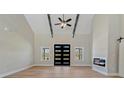 Bright living room with high ceilings, fireplace, and contemporary ceiling fan at 709 Oakridge View Trl, Ridgeville, SC 29472