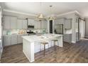 Modern kitchen with gray cabinetry, stainless steel appliances, and marble island at 772 Clay Field Trl, Summerville, SC 29485