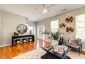Bright living room with hardwood floors, modern furniture, and decorative wall accents at 8938 Planters Row Ln, Summerville, SC 29485