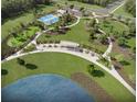 An aerial view showcases the community's park with a lake, walking paths, and recreation areas at 913 Dusk Dr, Summerville, SC 29486