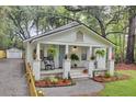 Inviting cottage with a rocking chairs, and lush landscaping at 920 Simmons Ave, Summerville, SC 29483