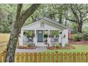 Charming cottage with a welcoming front porch, rocking chairs, and lush landscaping at 920 Simmons Ave, Summerville, SC 29483