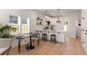 Well-lit kitchen with white cabinets, pendant lighting, and a breakfast bar with seating at St, Charleston, SC 29407
