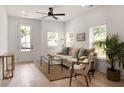Bright living room with hardwood floors, natural light, neutral-toned furniture, and potted plants at St, Charleston, SC 29407