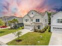 Well-manicured lawn surrounds a two-story home with a two-car garage and driveway at 106 Sago Ct, Summerville, SC 29486