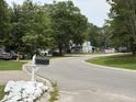 Scenic view of a quiet street with charming homes and lush greenery at 107 Tabby Creek Cir, Summerville, SC 29486
