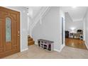 Spacious entryway with shoe storage, tile floors, stairs, and glass paneled doors at 112 Fox Chase Dr, Goose Creek, SC 29445