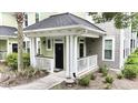Inviting covered porch with black door and white railings enhance curb appeal at 1225 Blakeway St # 906, Charleston, SC 29492