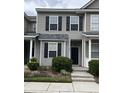 Two-story townhome featuring muted green siding, black shutters, and a well-maintained landscaped front yard at 126 Woodward Rd, Goose Creek, SC 29445