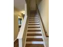 Classic wooden staircase with white risers and balustrade leads to the upper level of the home at 126 Woodward Rd, Goose Creek, SC 29445