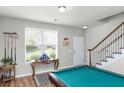 Basement game room featuring a pool table, neutral walls, and natural light filtering through the window at 1301 Wild Goose Trl, Summerville, SC 29483