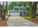 Traditional two-story home with a two-car garage and a well-maintained front lawn at 1552 Harborsun Dr, Charleston, SC 29412