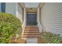 Inviting front entrance with brick steps, complemented by fresh landscaping and a classic double door at 1800 Palmetto Isle Dr, Mount Pleasant, SC 29466