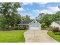 Charming single-story home features light blue siding, a two-car garage, and a well-manicured front lawn at 1928 Gasque St, Johns Island, SC 29455