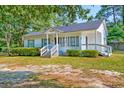 Inviting home featuring a cozy front porch and well-kept landscaping for a welcoming appeal at 208 State St, Walterboro, SC 29488