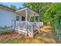 Covered porch with gray and white trim, white pickets, and a view of the wooded yard at 208 State St, Walterboro, SC 29488