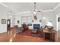 Comfortable living room featuring a fireplace, ceiling fan, and hardwood floors at 2257 Magnolia Meadows Dr, Mount Pleasant, SC 29464