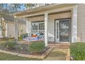 Inviting covered front porch with brick flooring, a porch swing, and decorative columns offer a cozy outdoor space at 240 Mayfield Dr, Goose Creek, SC 29445