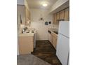The kitchen features light cabinets, laminate countertops, and white appliances at 2494 Etiwan Ave # 9-D, Charleston, SC 29414