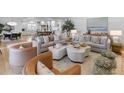 Open-concept living room features stylish furnishings, a cozy atmosphere, and natural light throughout the space for comfortable living at 27 Watroo Pt, Daniel Island, SC 29492