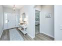 Welcoming entryway featuring wood floors, white trim, console table and rug at 302 Fiddleback Dr, Summerville, SC 29486