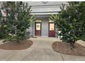 Inviting entrance with cozy bench and mature trees enhancing the charm of the home at 3104 Mariners Way, Moncks Corner, SC 29461