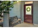 Charming front door with wreath, bench, and ample sunlight at 3104 Mariners Way, Moncks Corner, SC 29461