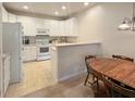 Bright kitchen with white cabinets, modern appliances, and an adjacent dining area perfect for Gathering meals at 3104 Mariners Way, Moncks Corner, SC 29461