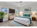 Bright bedroom features a large window, a modern dresser with a TV, and stylish decor at 3214 Pinewood Dr, Ladson, SC 29456