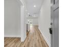 Inviting hallway with light wood floors leading to a bright living area and backyard at 3218 Pinewood Dr, Ladson, SC 29456